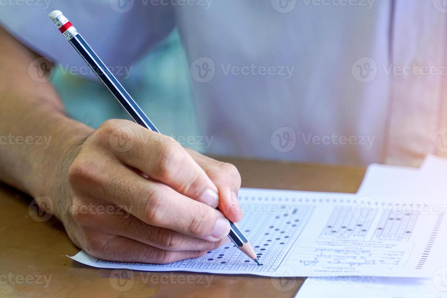 Asian students are taking exams to measure learning in the classroom. Soft and selective focus. photo