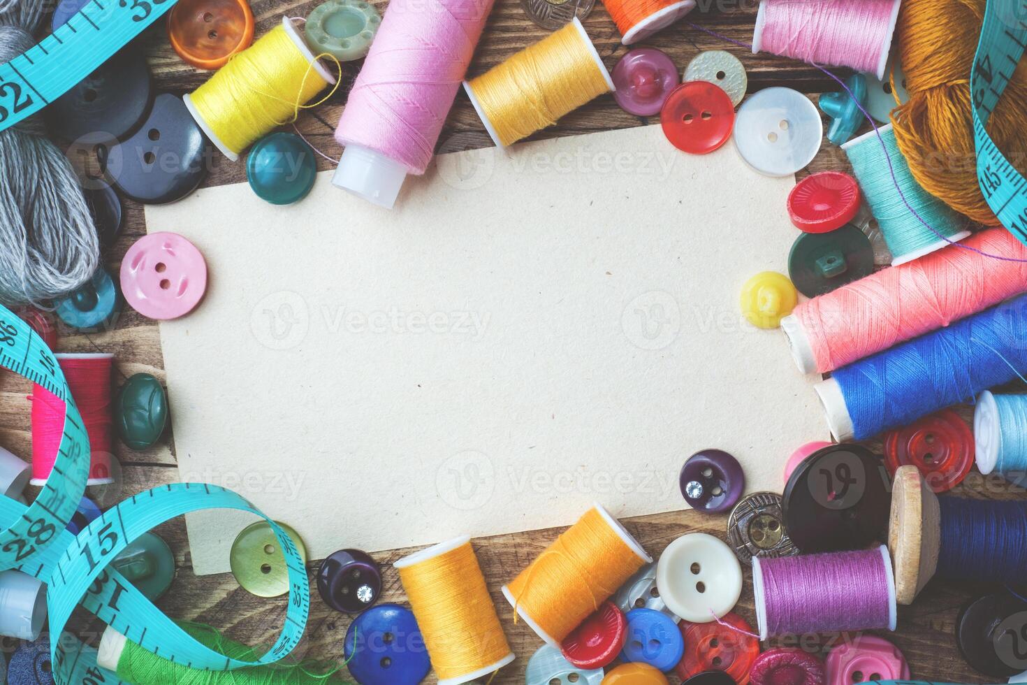 Colored threads centimeter and buttons, pair of scissors on the table. Copy space photo
