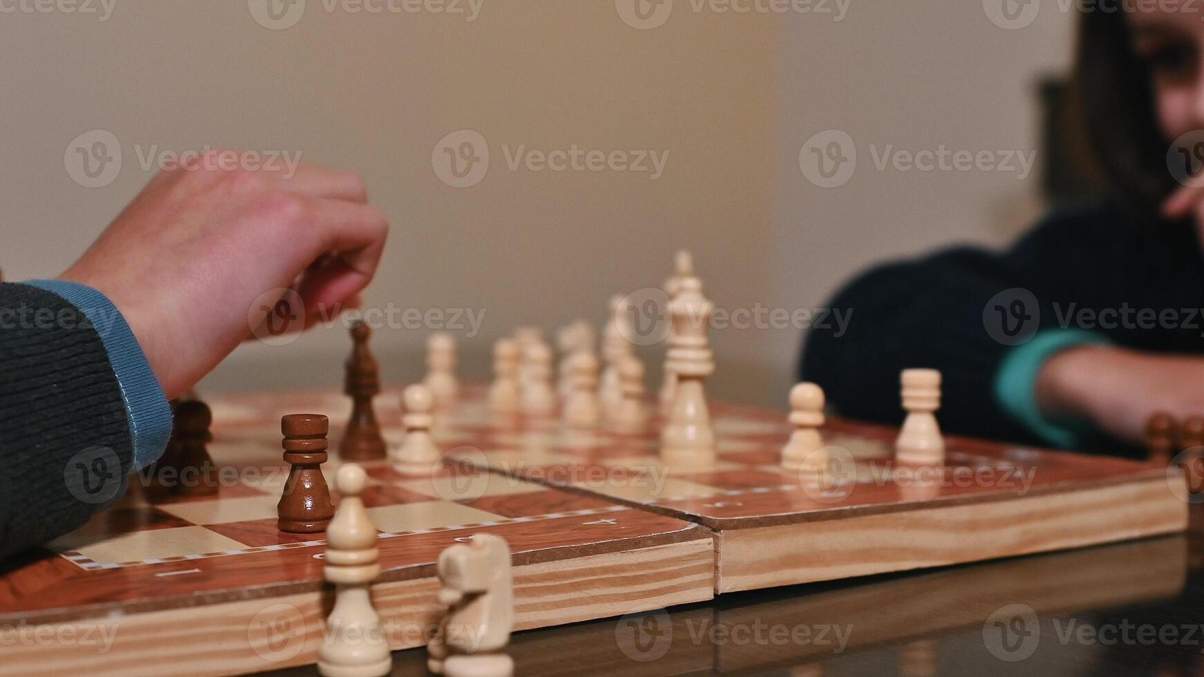 Two people strategizing during a focused chess board game match photo