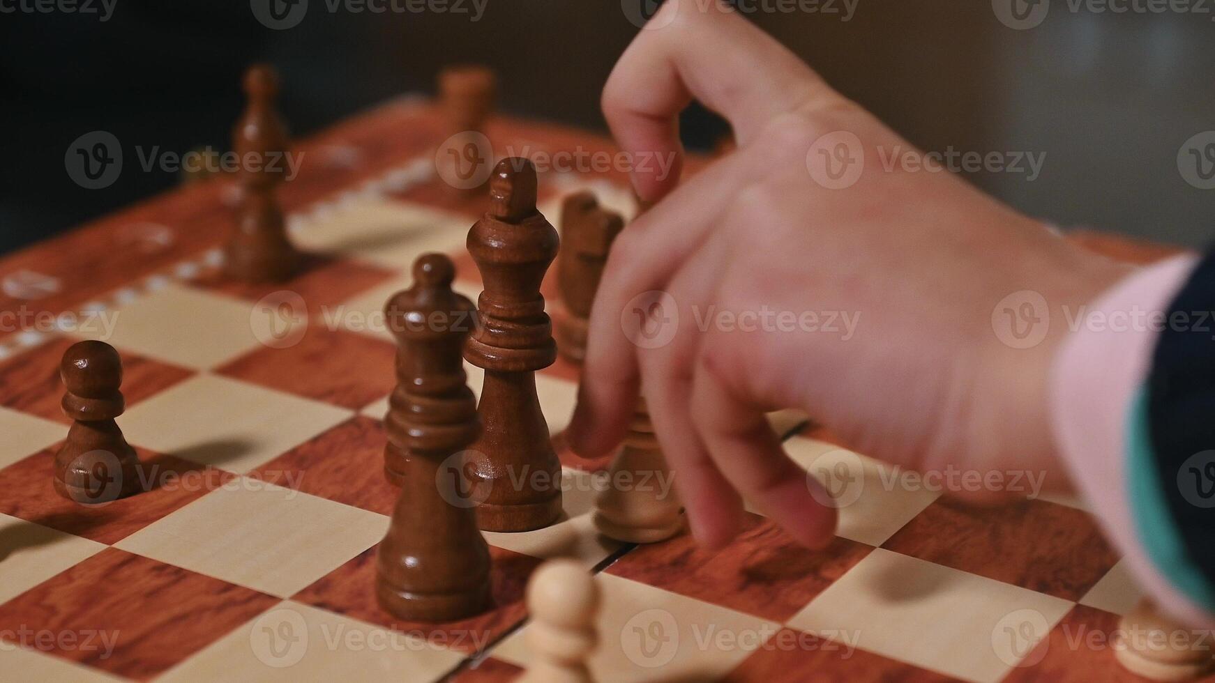 Close-up of a chess game with a player making a strategic move photo
