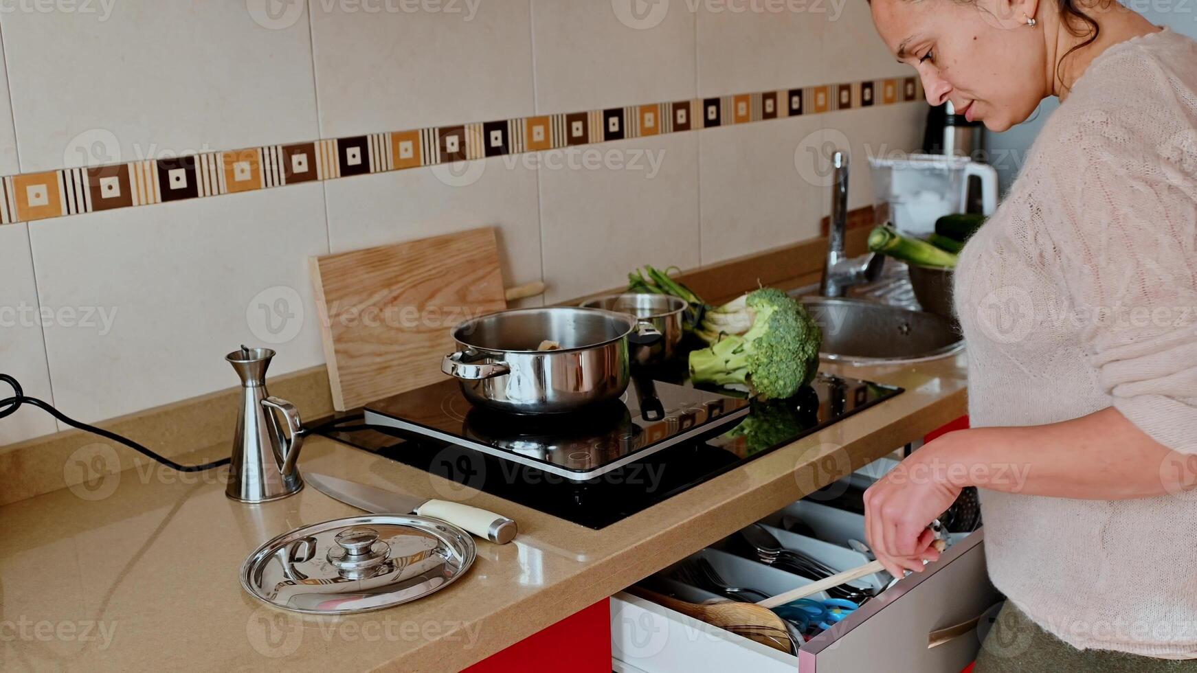 Woman preparing a healthy vegetable meal in a modern kitchen photo