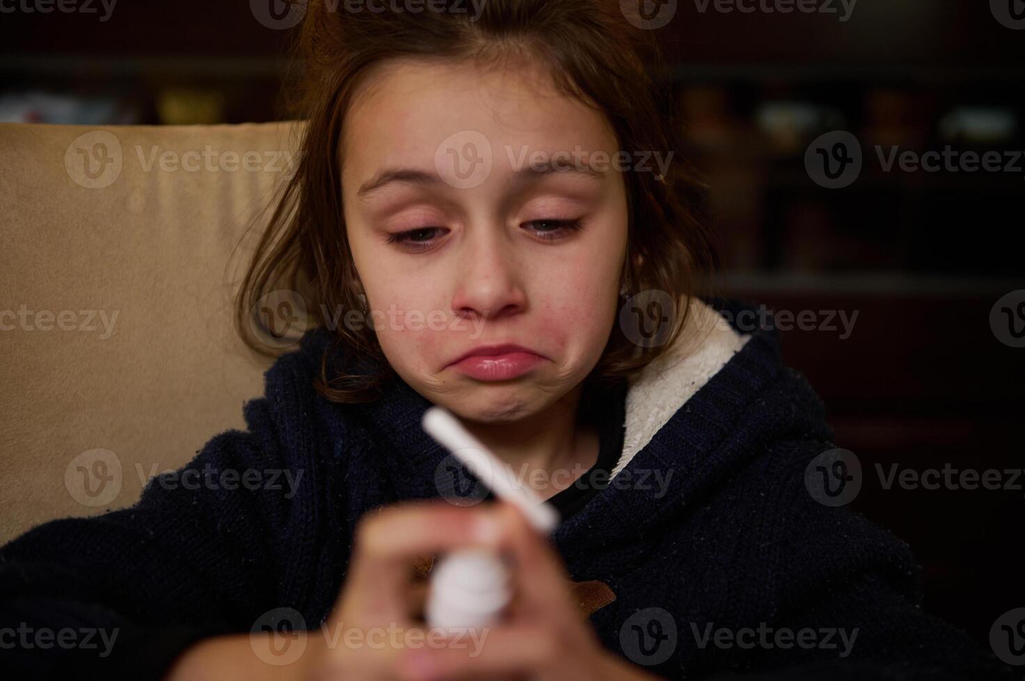 Close-up of a child showing emotion with a focus on facial expression photo