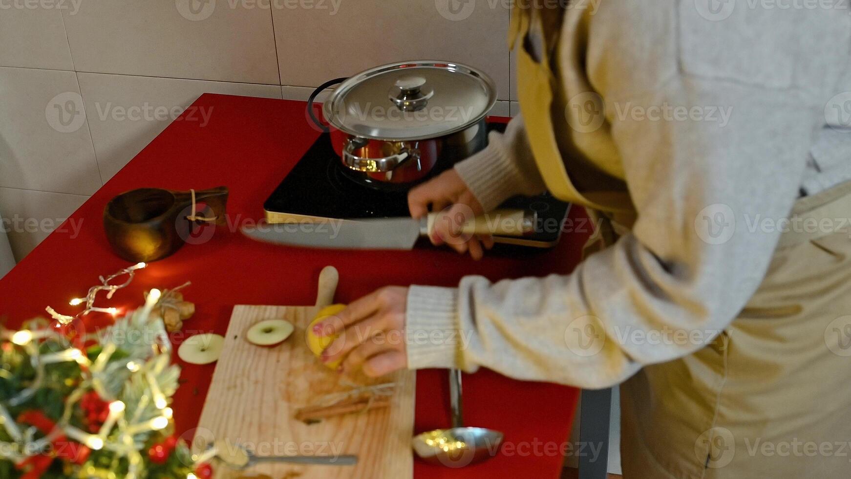 Woman preparing ingredients in a cozy kitchen during the holiday season photo