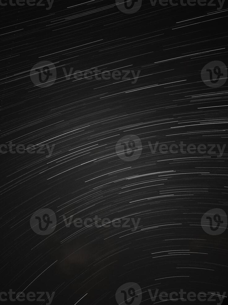 Long Exposure Star Trails Over Night Sky. photo