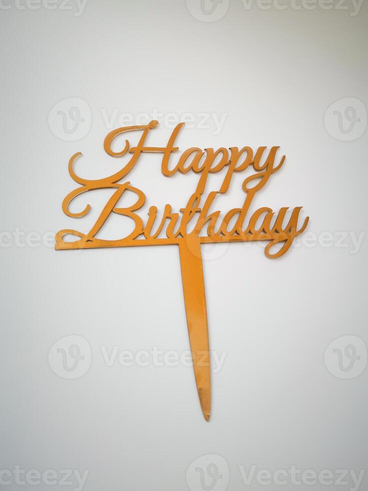 Gold Happy Birthday Cake Topper perfect for adding a festive touch to any birthday cake, topper is made of a durable material and features elegant calligraphy isolated on white background top view photo