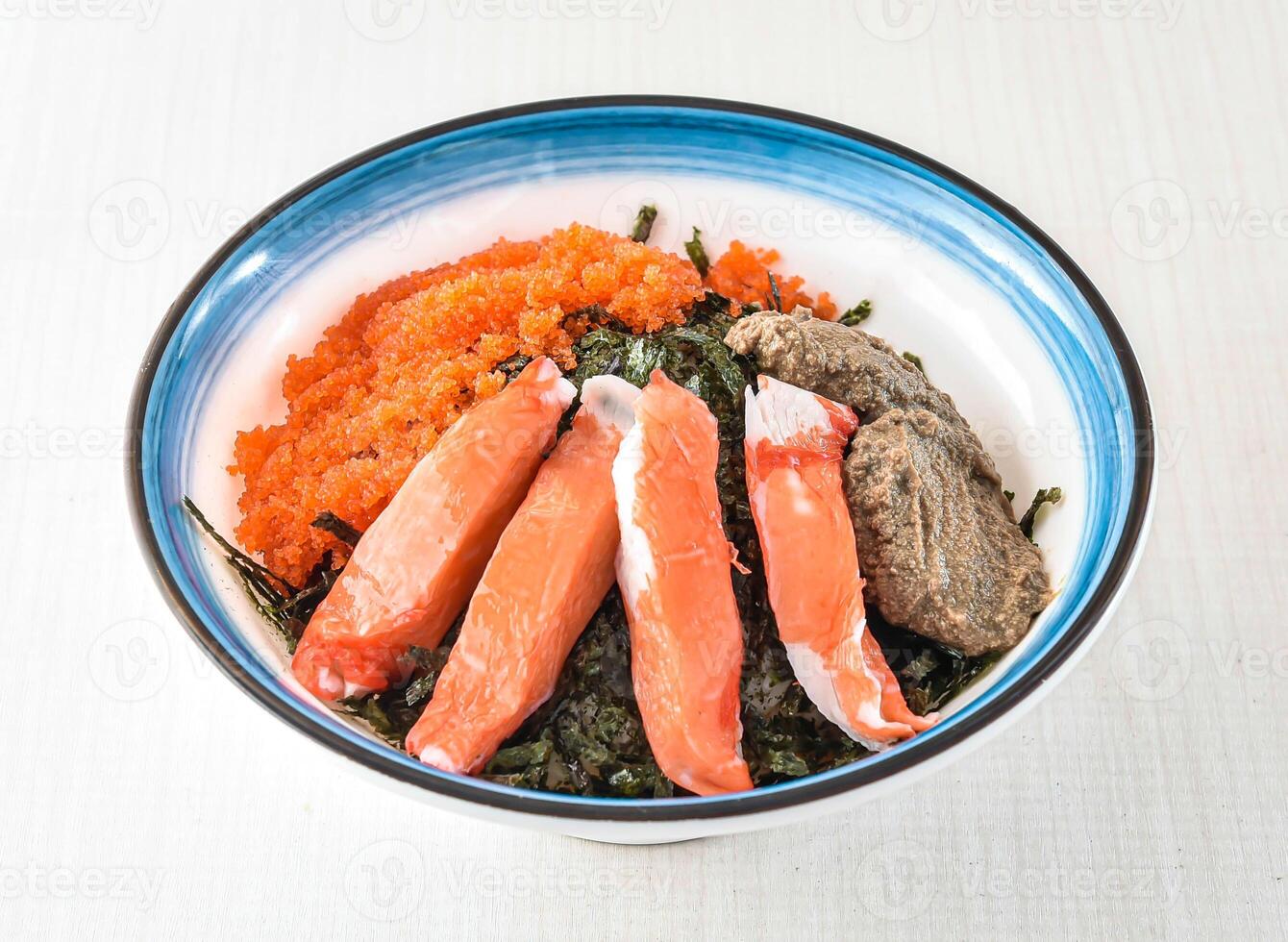Korean style crab paste rice Seafood Rice Bowl with Ikura served in bowl isolated on white background side view of hong kong food photo