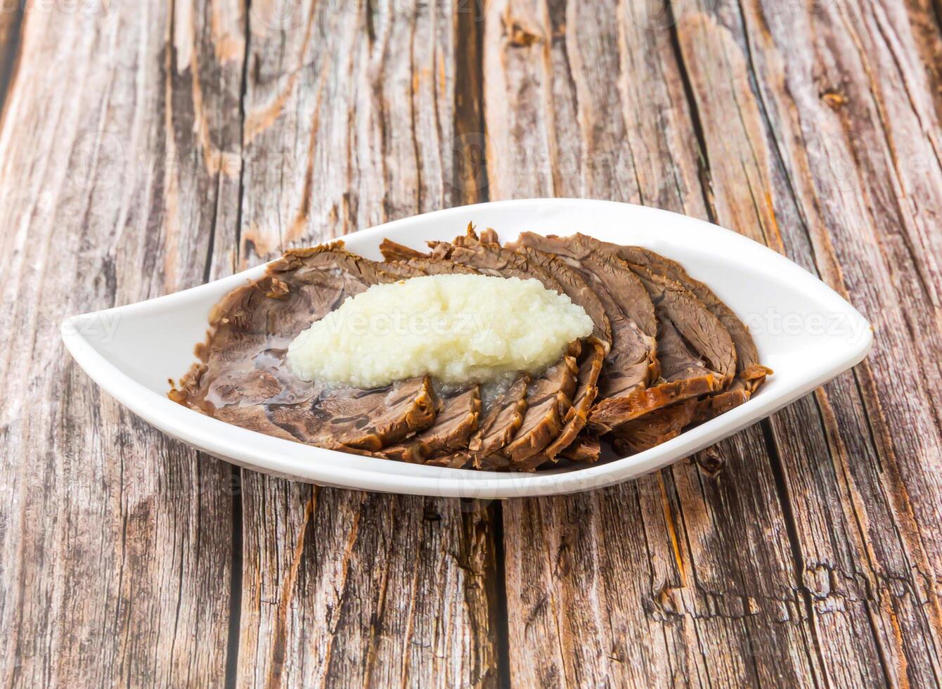 Garlic Beef Stew topped with garlic paste served in dish isolated on wooden table side view of hong kong food photo