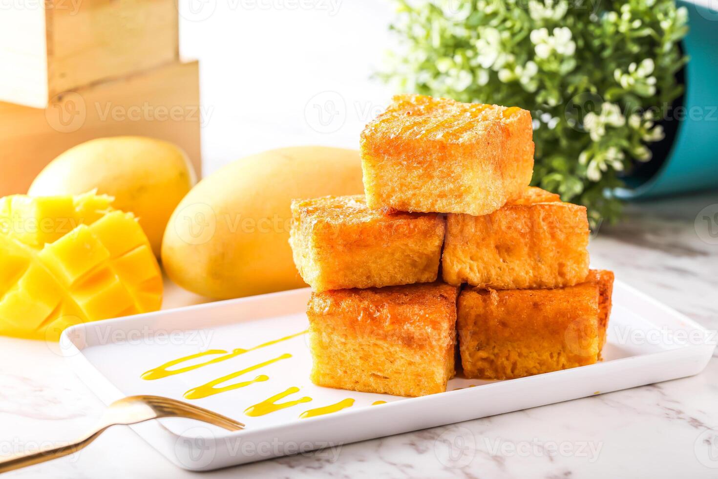 Mango Gold Brick west Toast Stack served in tray dish with fork isolated white marble background side view of hong kong food photo