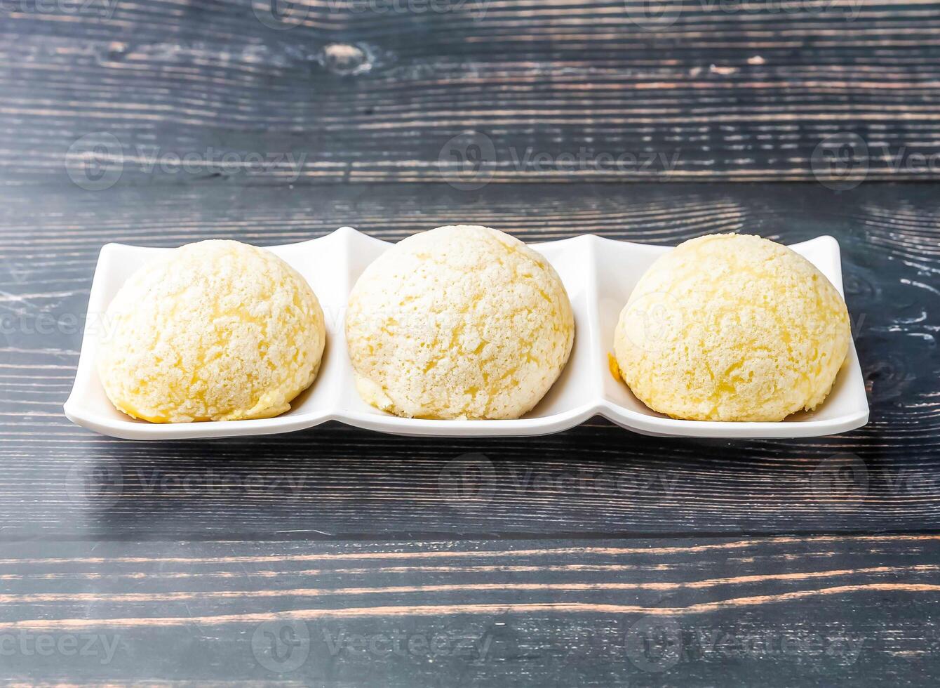 Chinese Barbecued Pork Buns served in tray dish isolated on wooden table side view of hong kong food photo