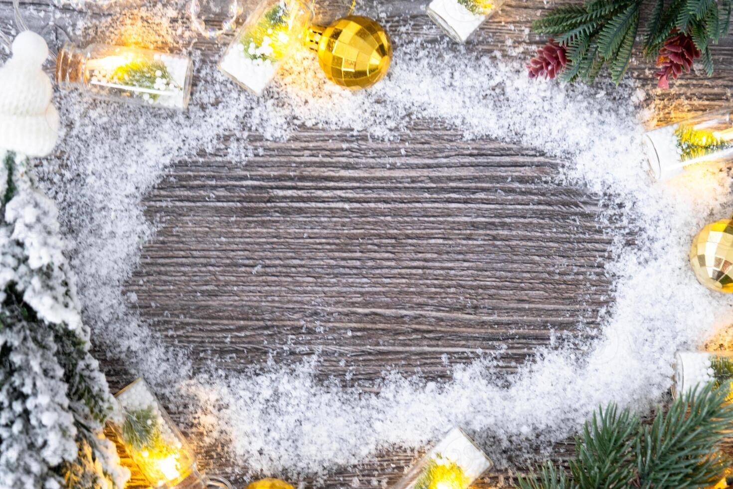 Festive frame with a place for Christmas and New Year's theme text. Snow, stars, garland on grey wooden background. Copyspace, greeting card photo