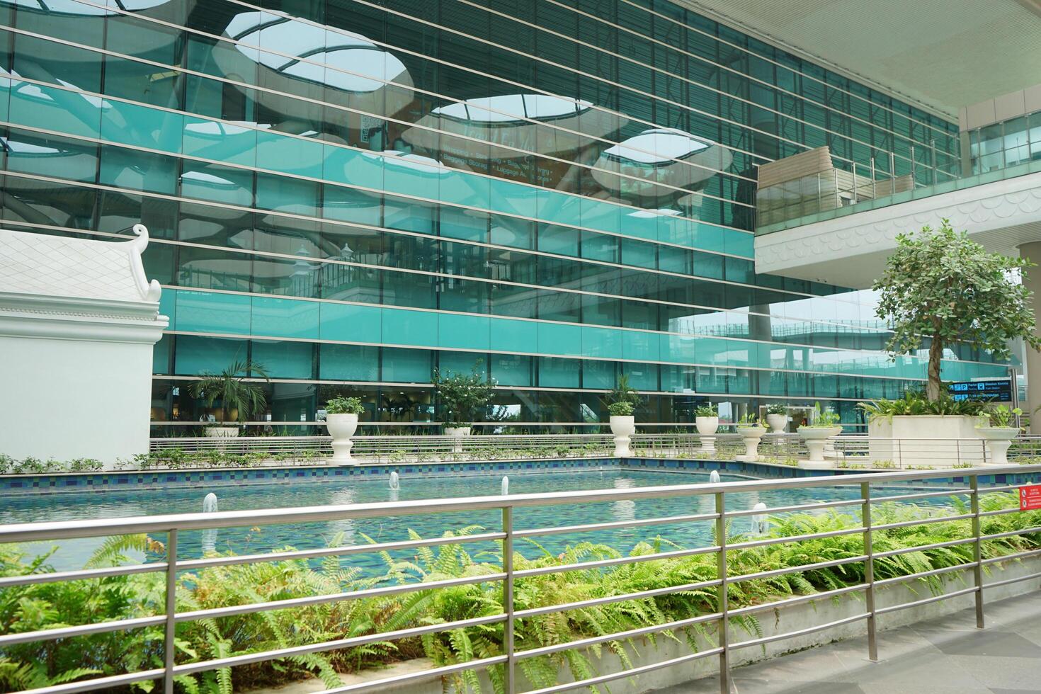 a large building with a pool in front of it at the new yogyakarta international airport photo