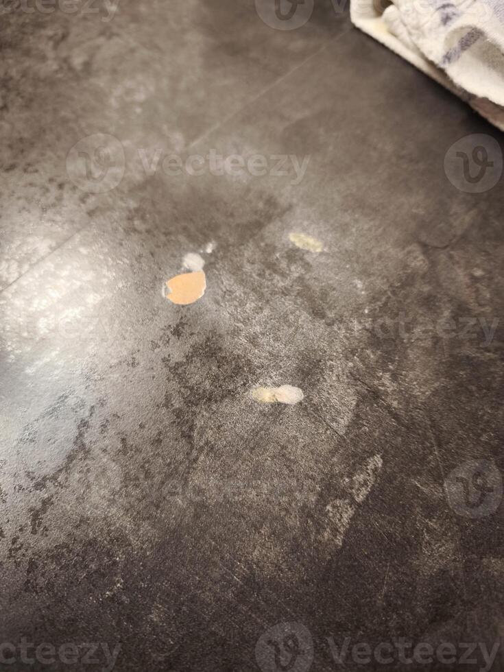 Damaged countertop showing peeling laminate and particleboard underneath photo