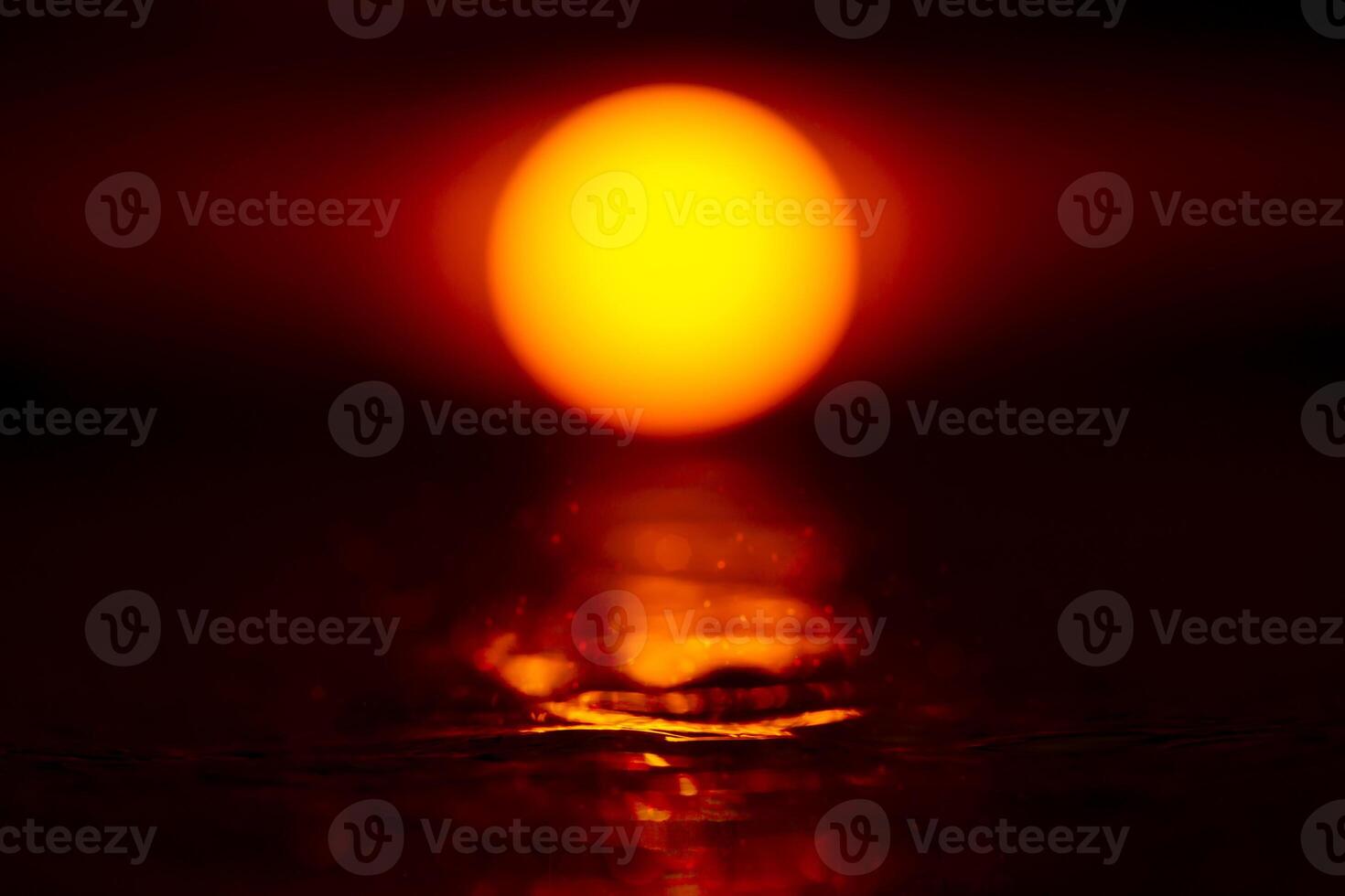 Sunset sky with big sun mirror on the water in the dark sky. photo