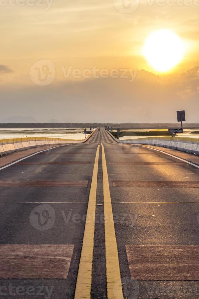 Empty road and the traffic lines with sunlight. photo