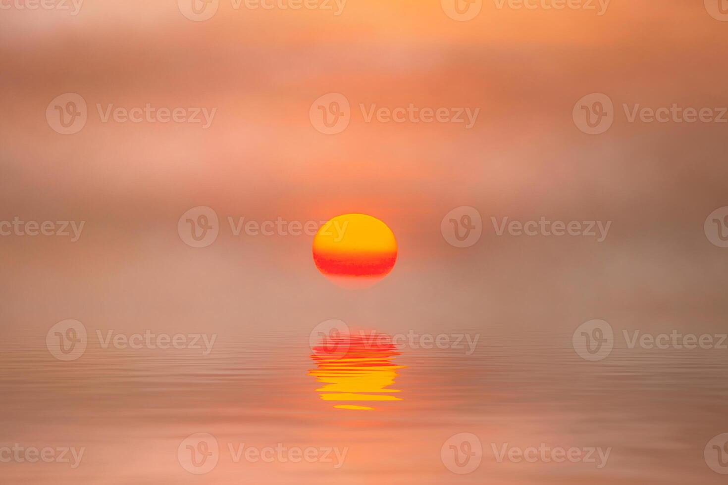 Sunset reflection at the lake with soft mist. photo