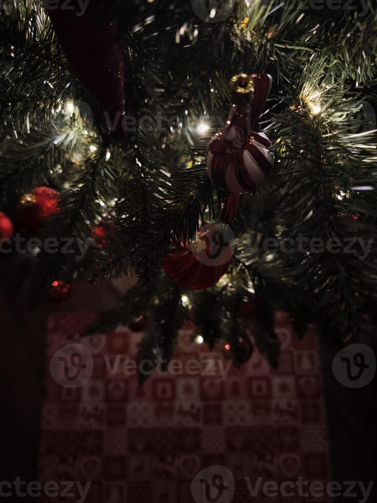 Christmas tree decorated with red and white ornaments and lights illuminating advent calendar photo