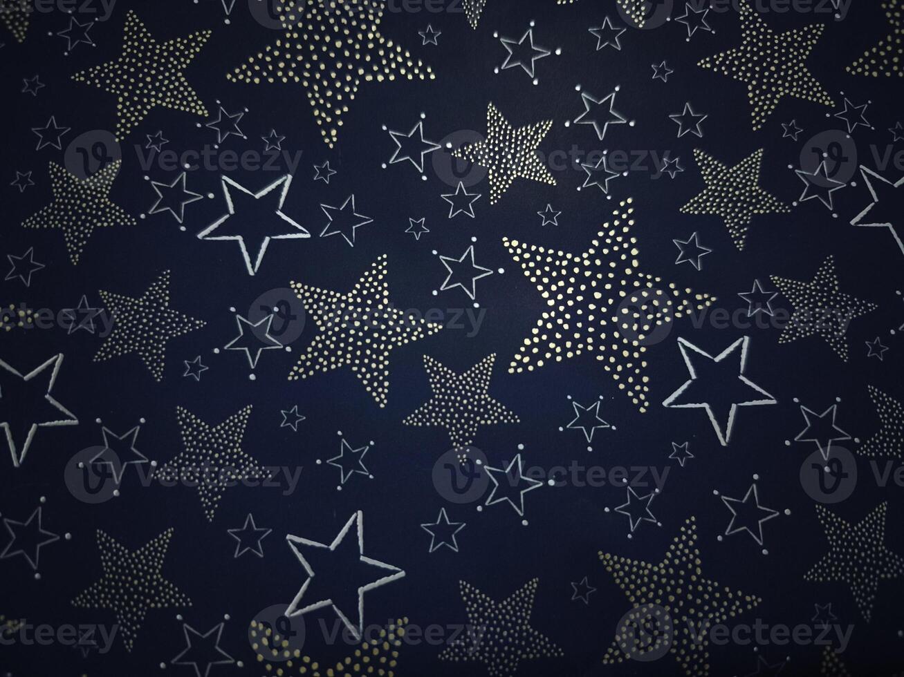 Golden and silver stars creating festive christmas atmosphere on dark blue background Gift boxes New Year preparation decor photo