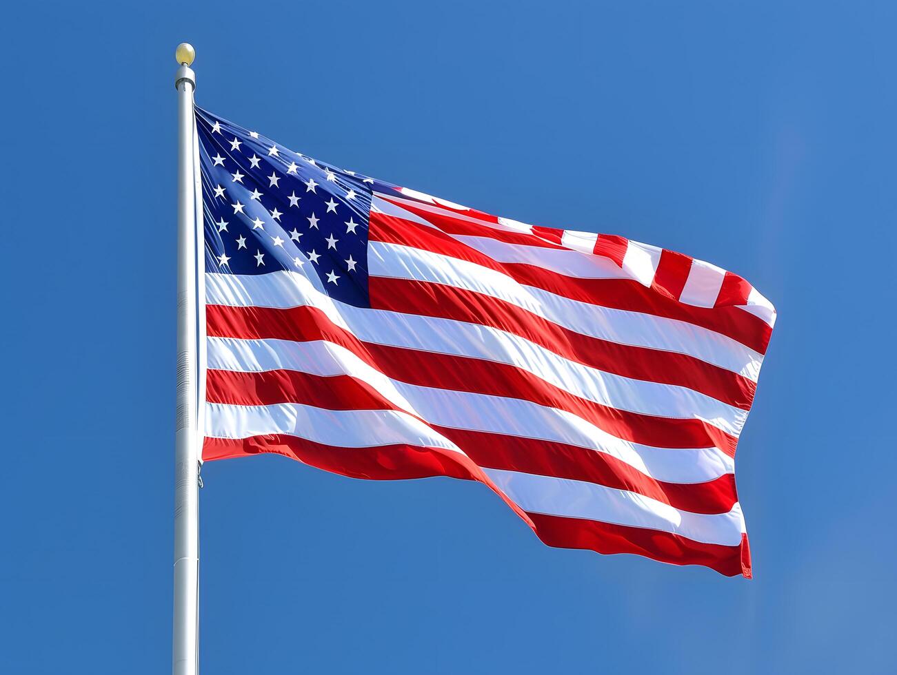 American flag waving against a clear blue sky photo