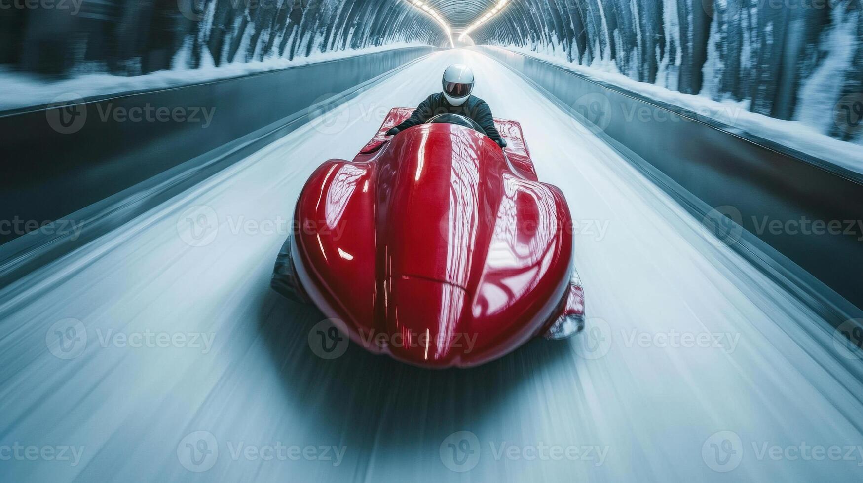 Professional bobsledder driving red bobsleigh at high speed in icy tunnel photo