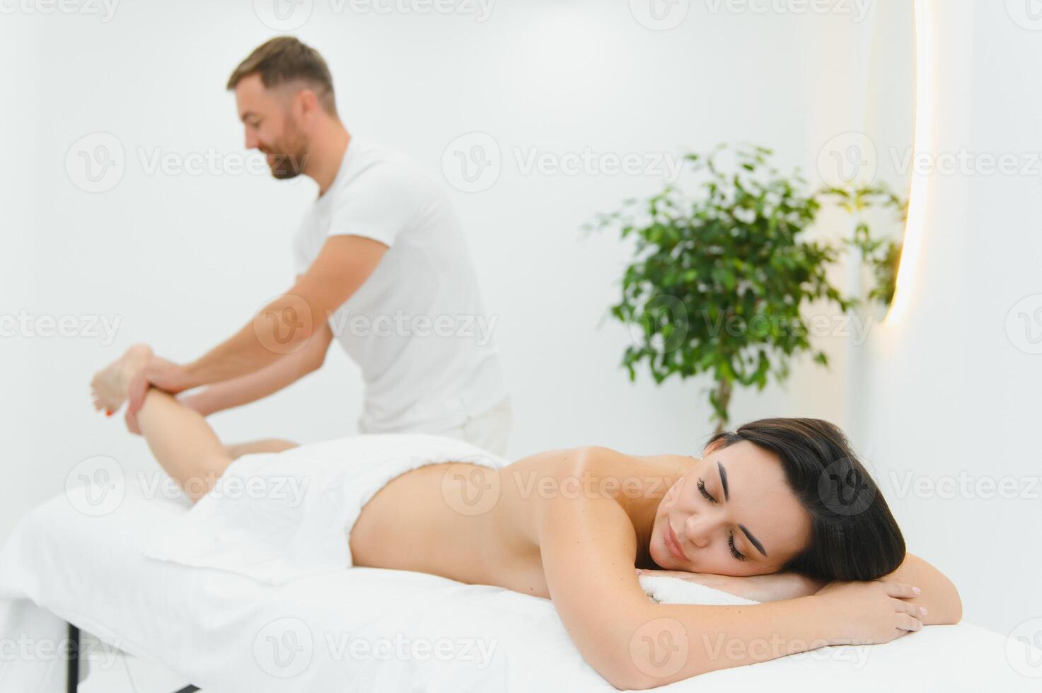 Woman getting relaxing feet massage with oils after long day photo