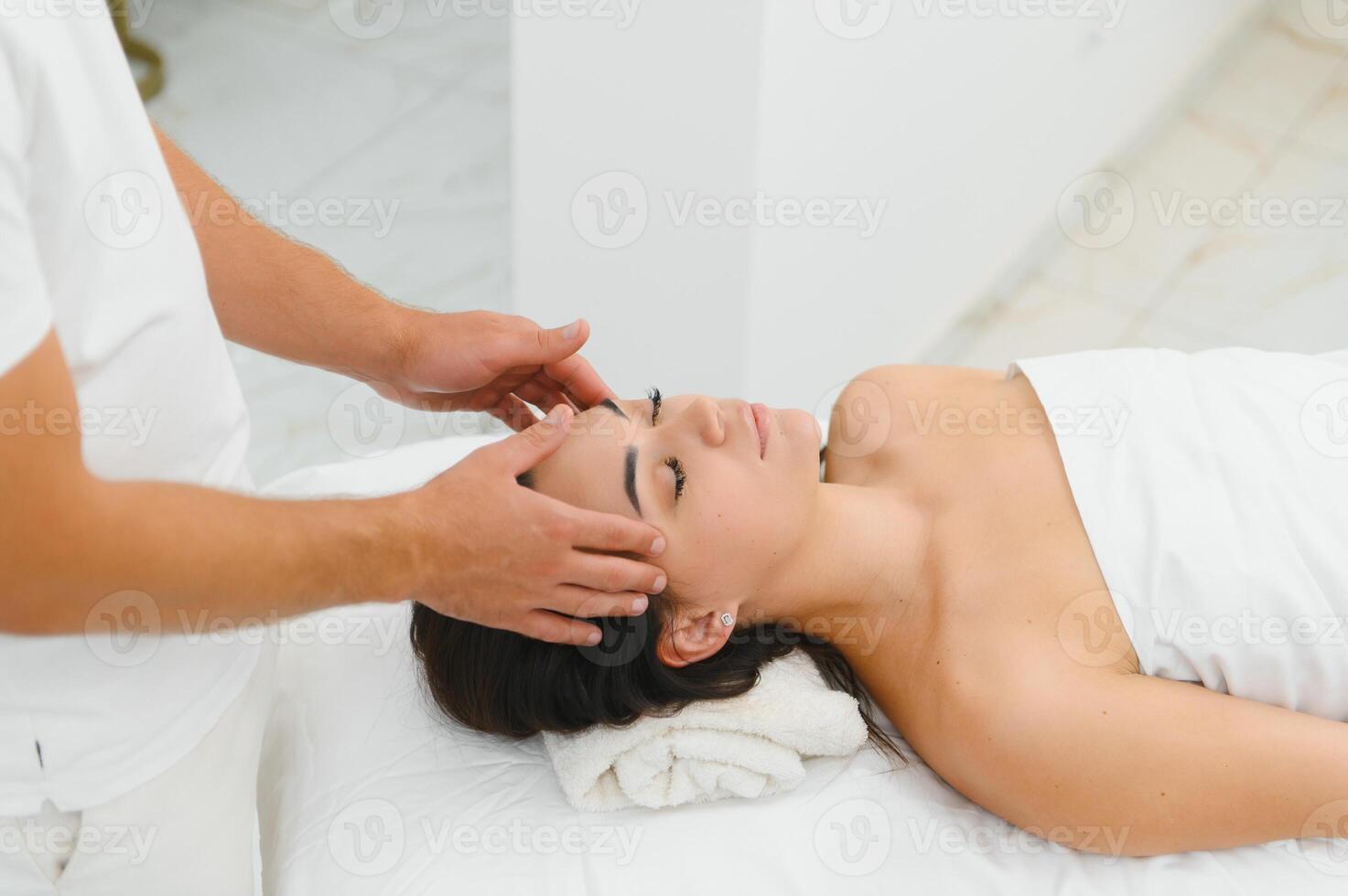 Theres no better way to relax. Shot of an attractive woman enjoying a face massage photo