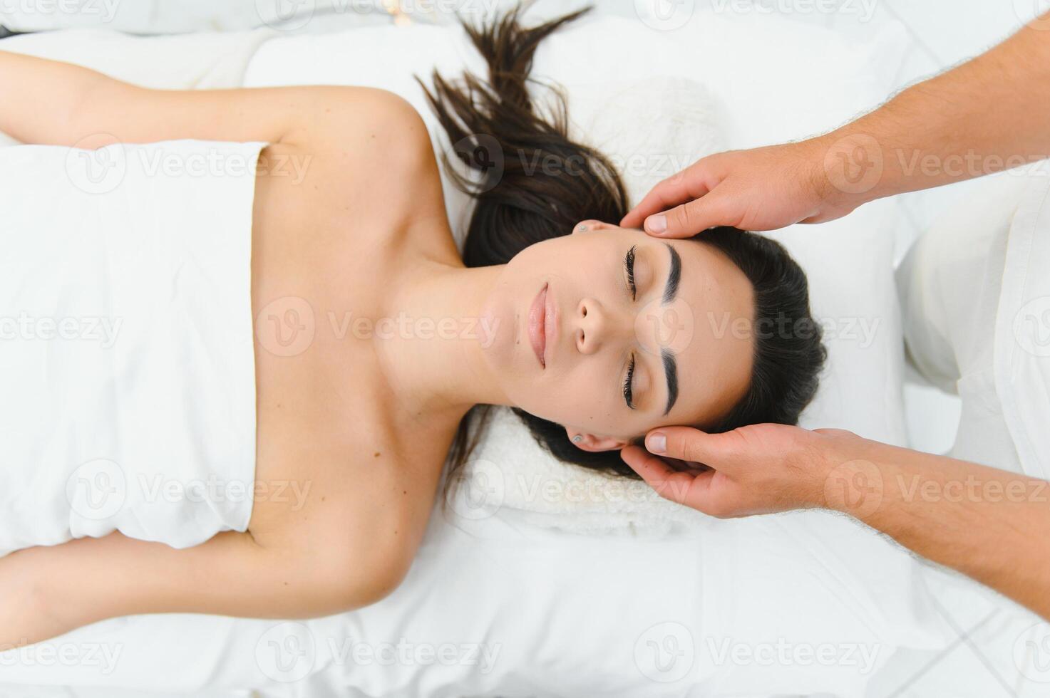 Theres no better way to relax. Shot of an attractive woman enjoying a face massage photo
