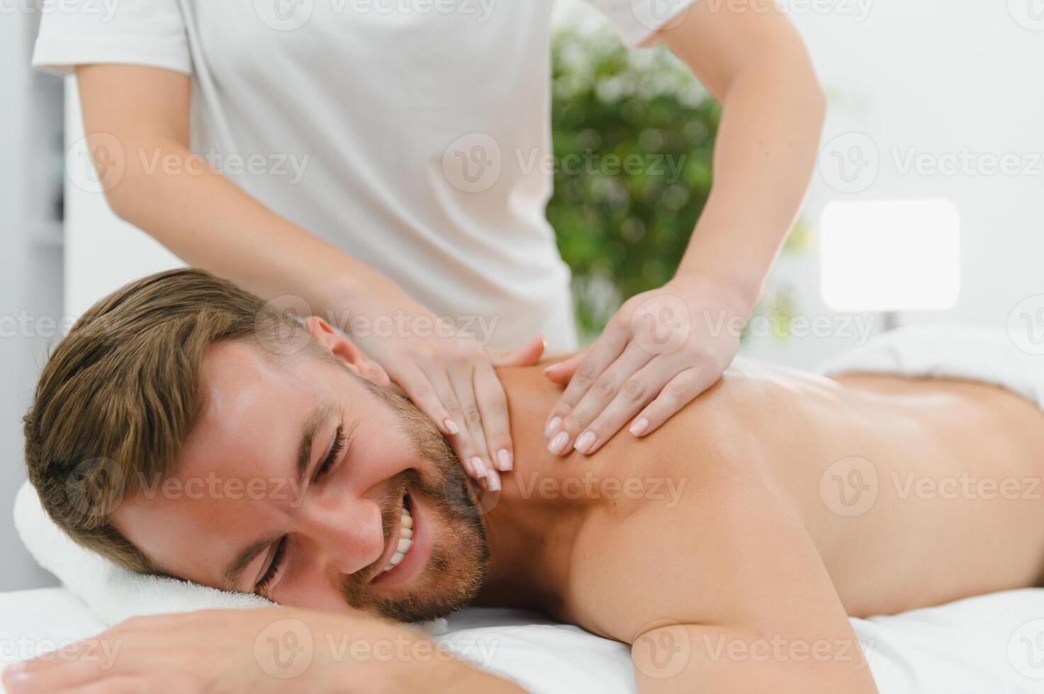 Handsome middle-aged man enjoying relaxing spa massage with oils photo