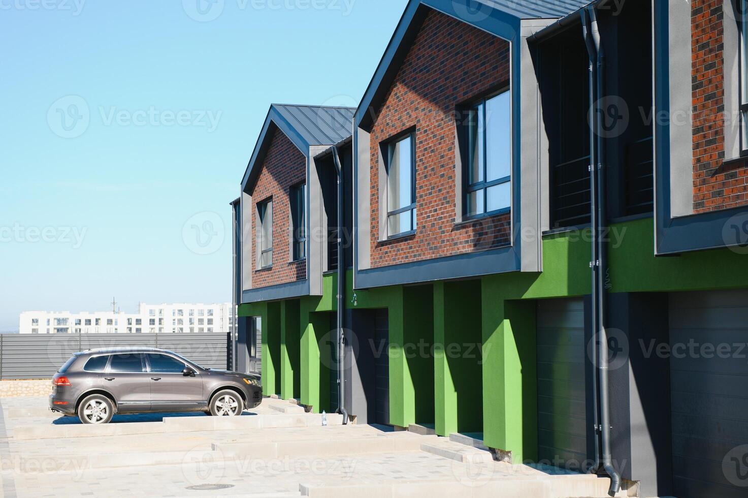 A row of residential townhomes or townhouses in suburb. Concept of real estate development, the housing market, and homeownership photo