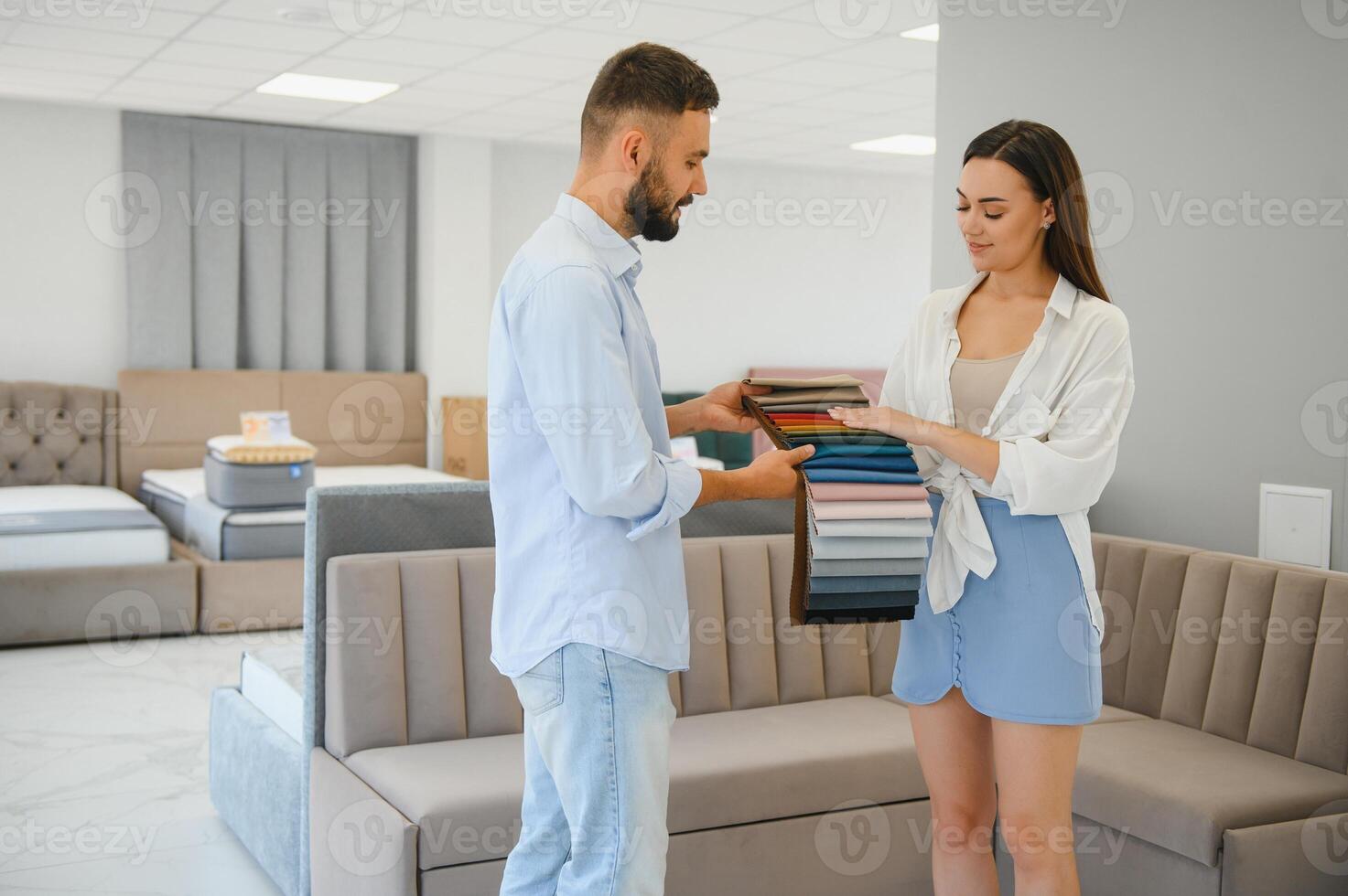 Married couple chooses the best new sofa in a furniture store photo