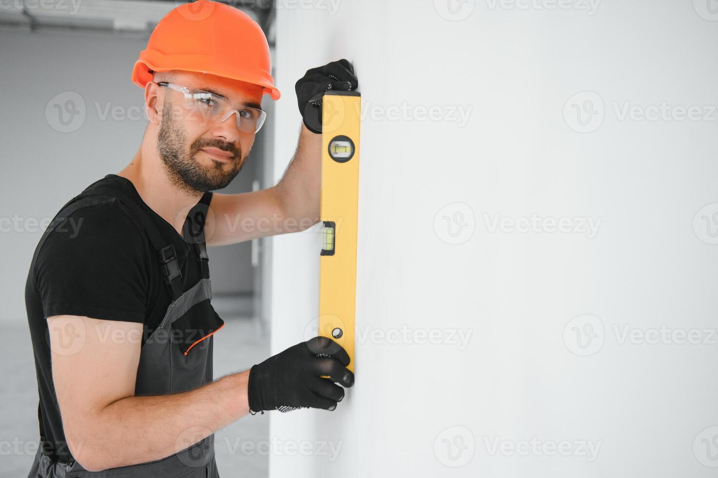 Construction Worker in uniform with spirit level photo