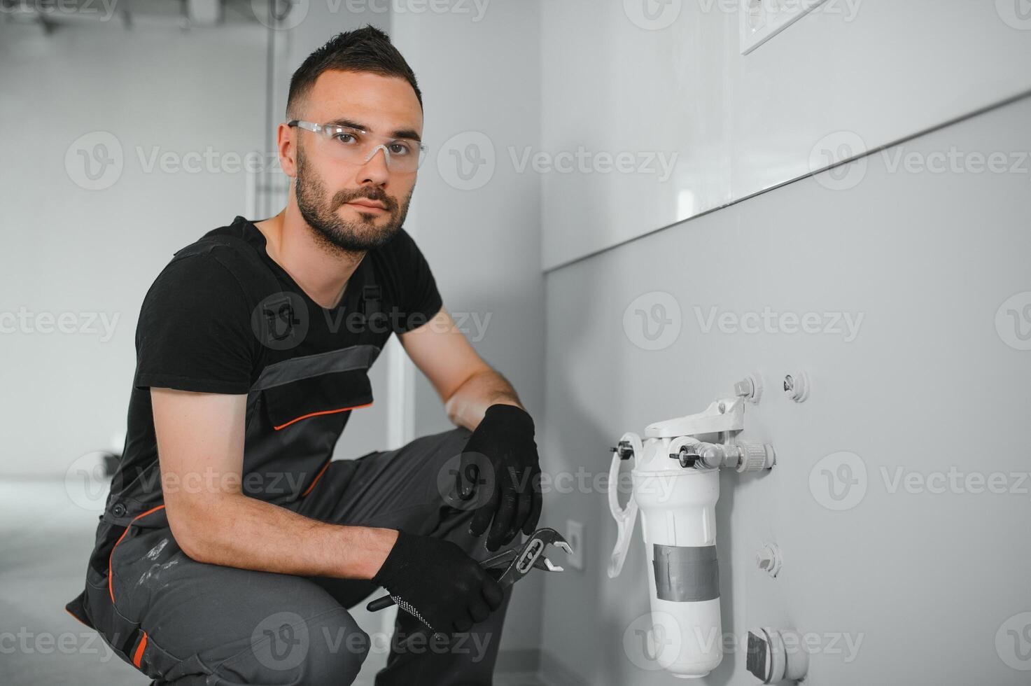 Plumber installs or change water filter. Replacement aqua filter. photo