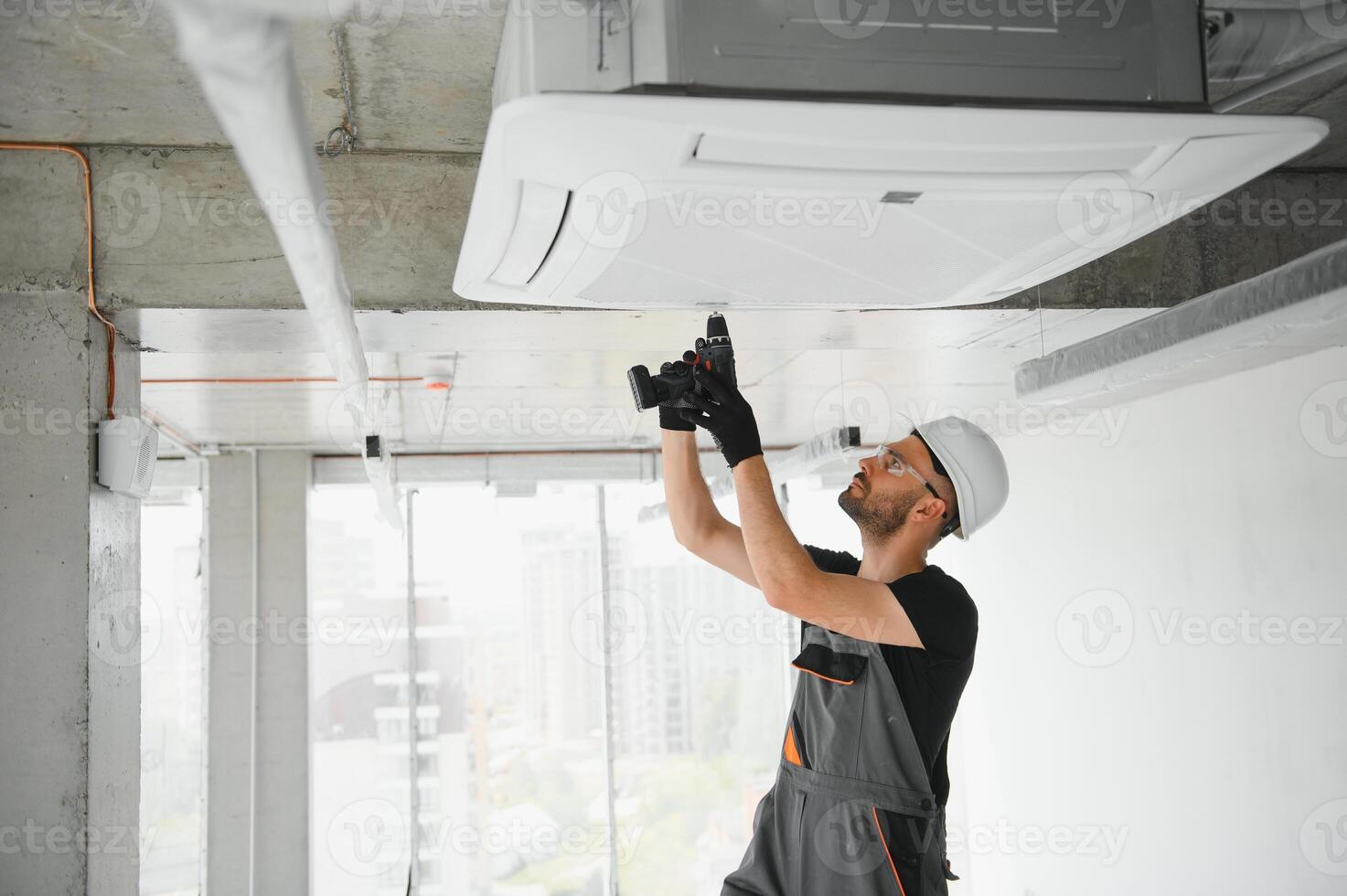 technician cleans air conditioner system in a modern apartment photo