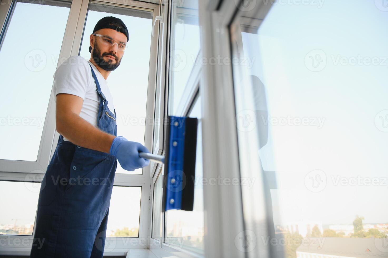 Cheerful male person cleaning window photo