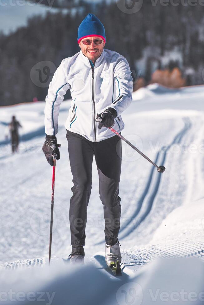 Man practices Nordic skiing with classic technique photo