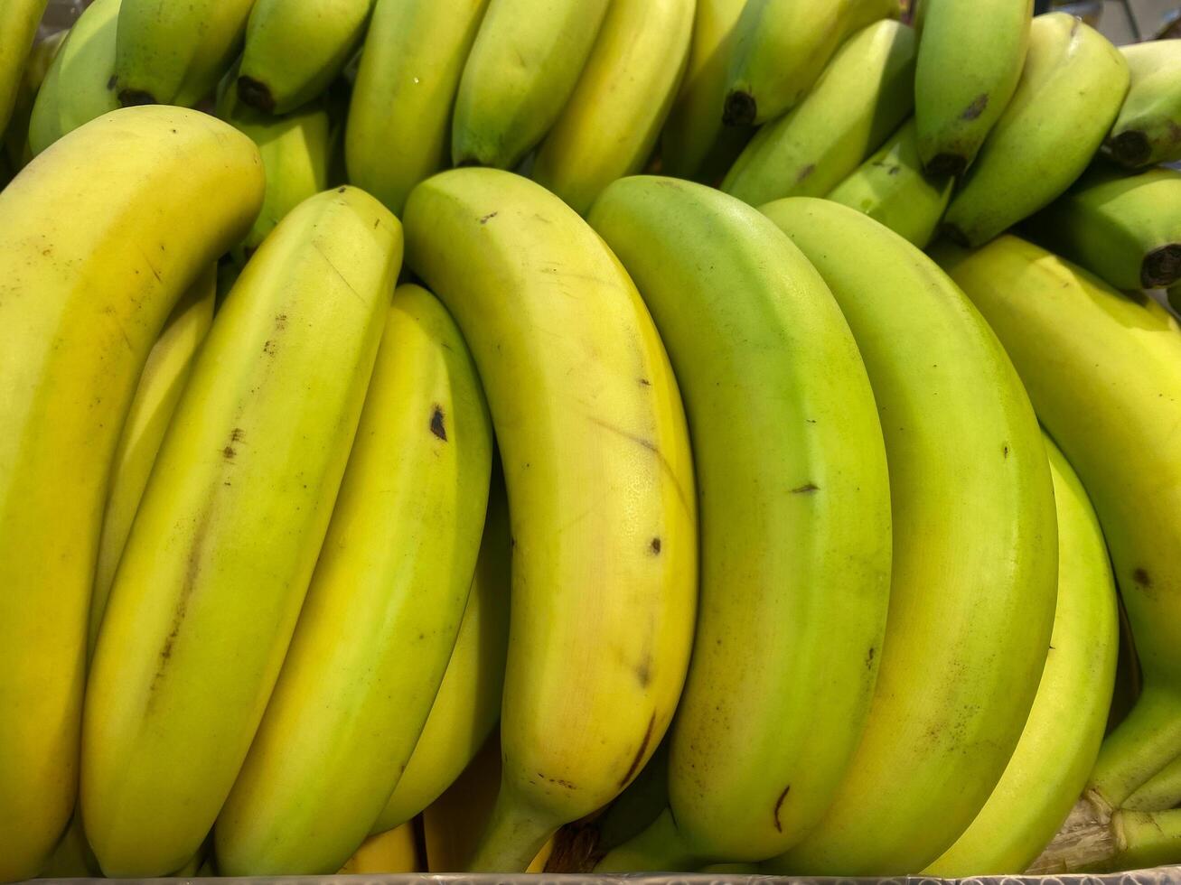 Banana branches in a crate at the store photo