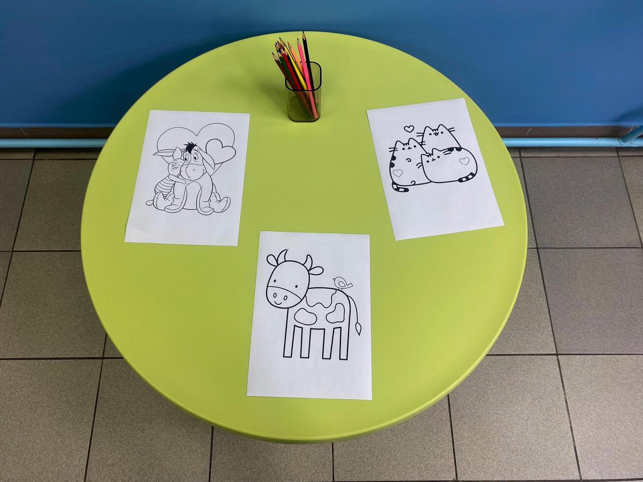 Round table for children with drawings photo