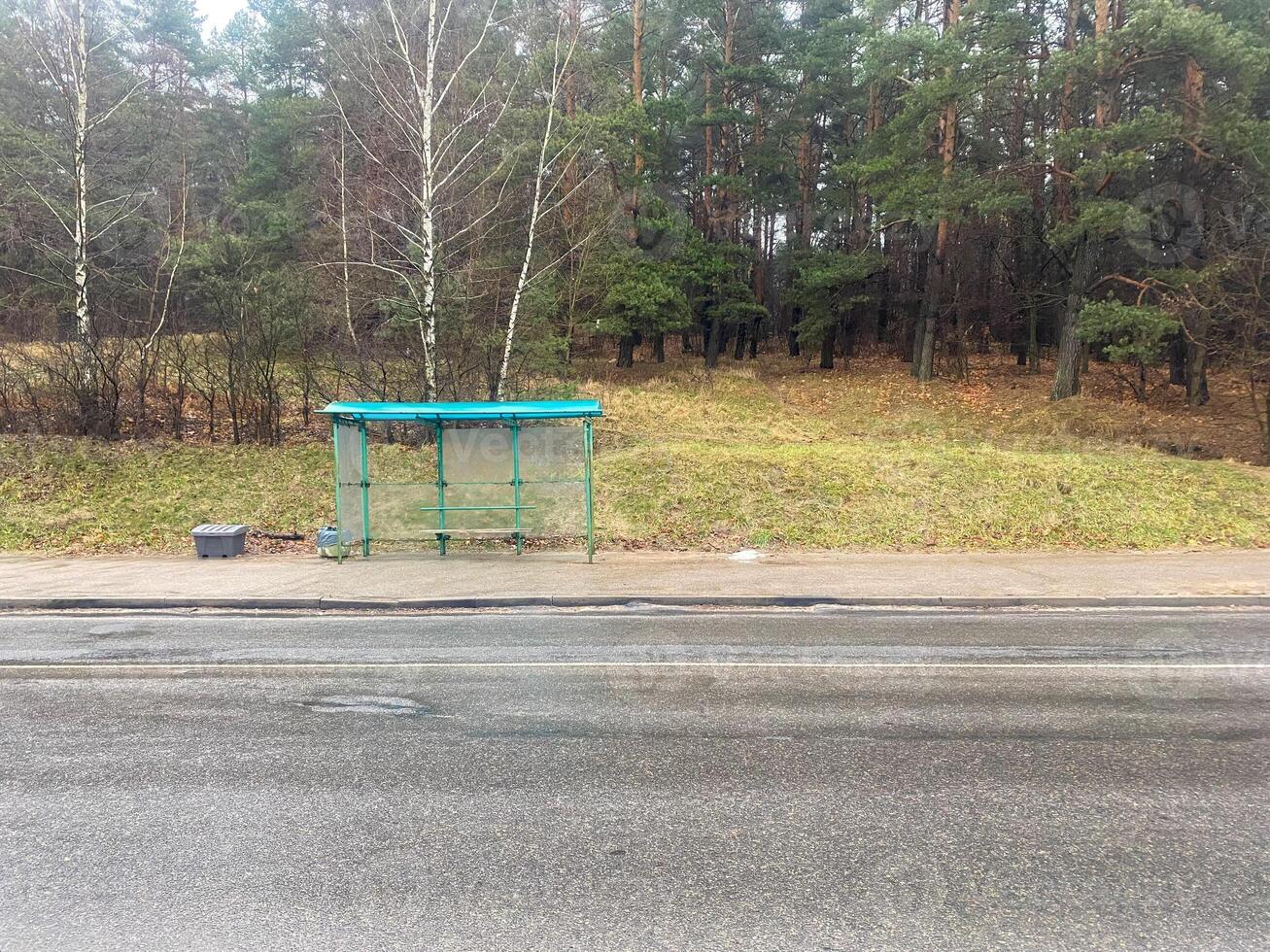 An empty stop near the woods photo