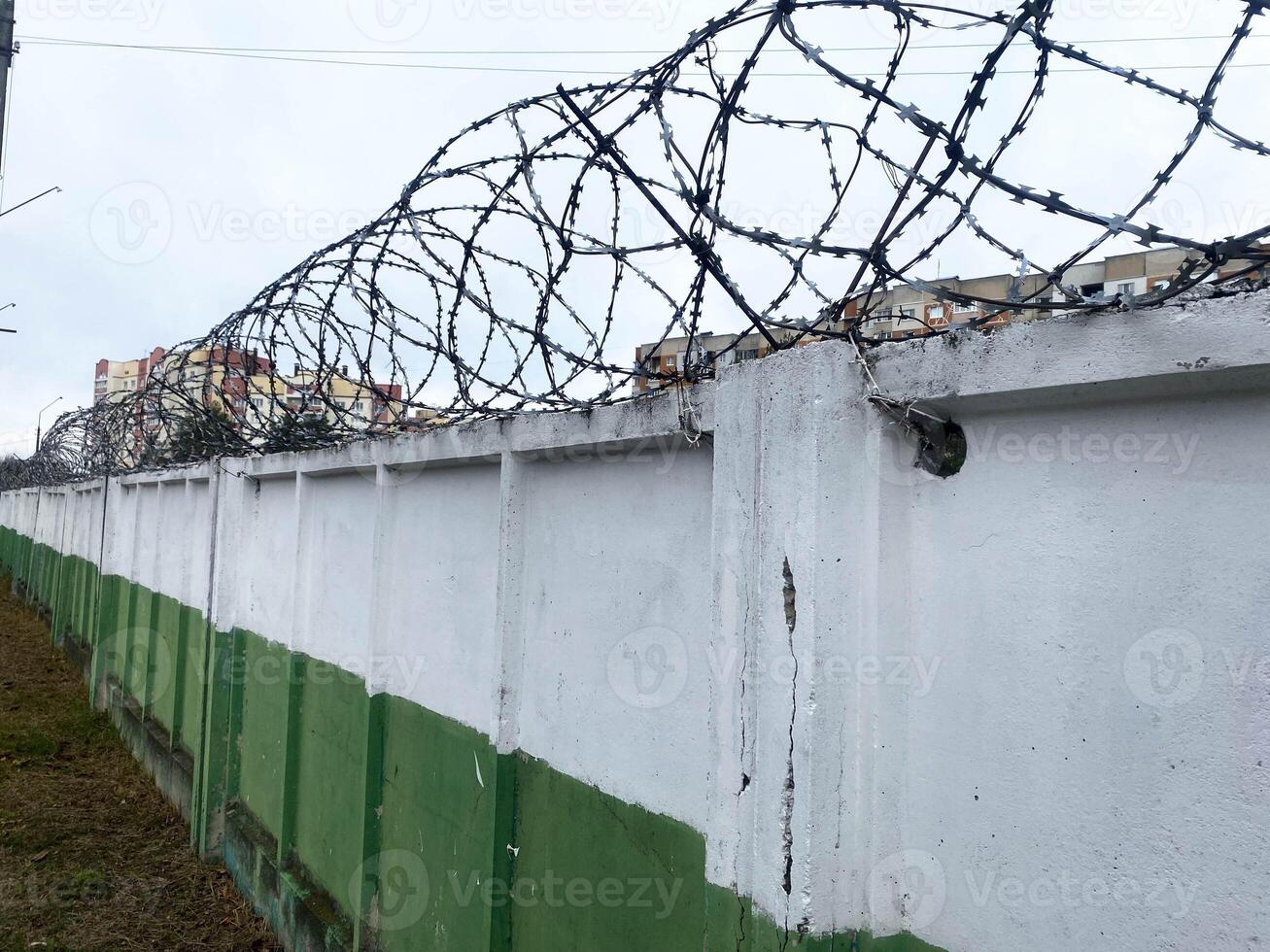 Barbed wire on a fence. High fence. Protected area photo