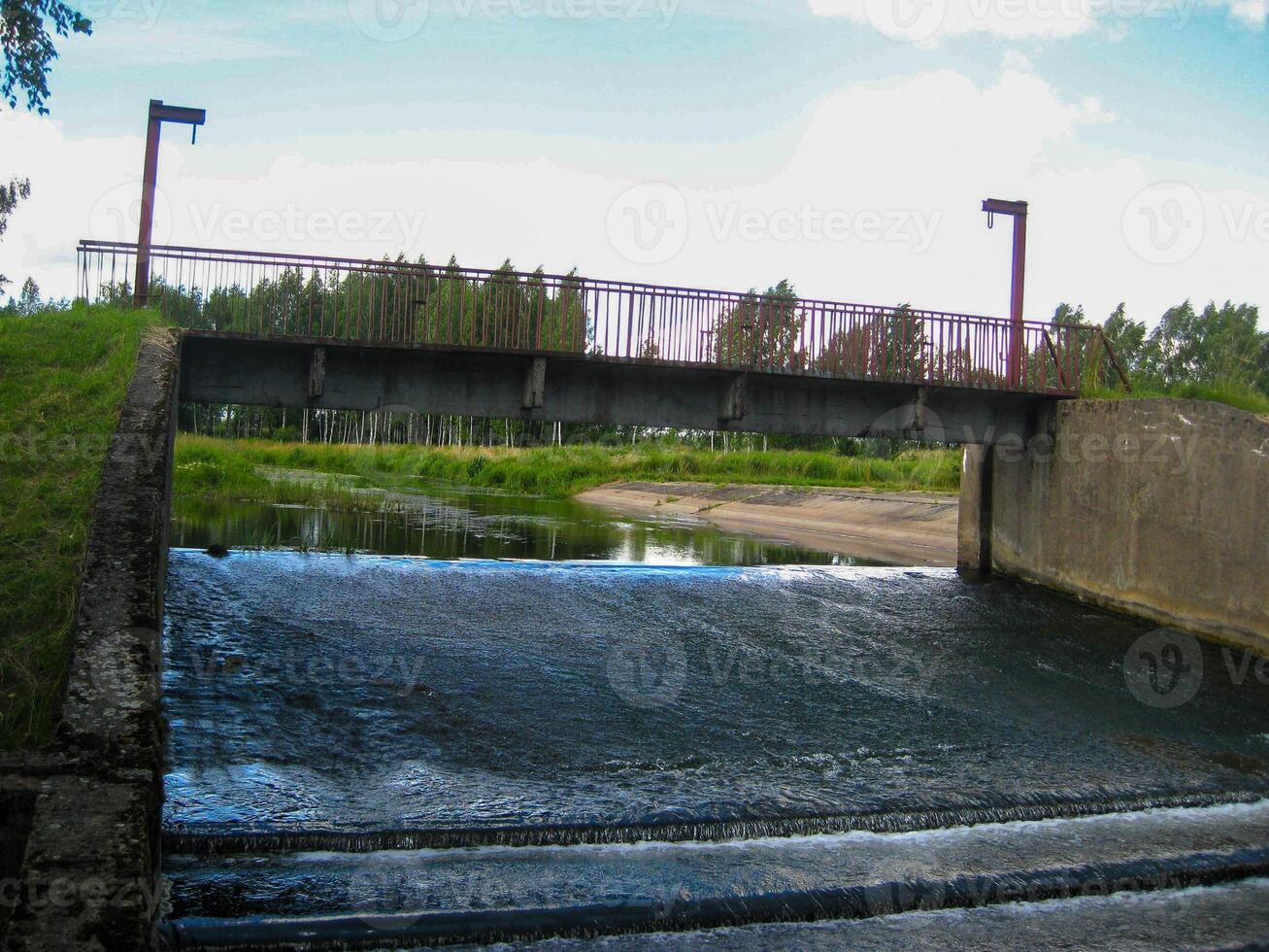 Water ladder. Water channel. River in the summer in the forest photo
