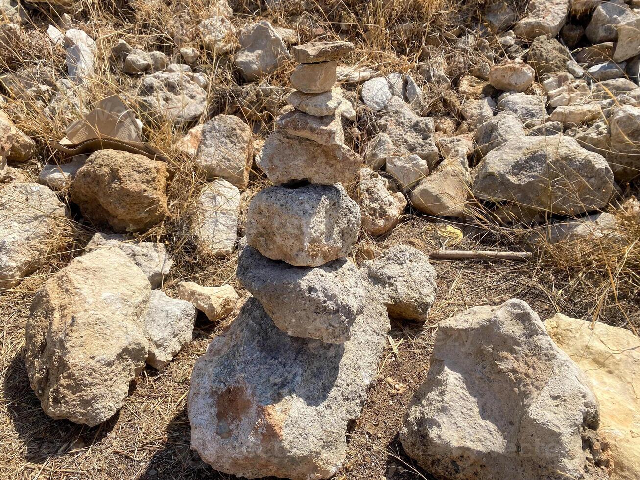 Stones in a dry place. Pyramid of stones photo