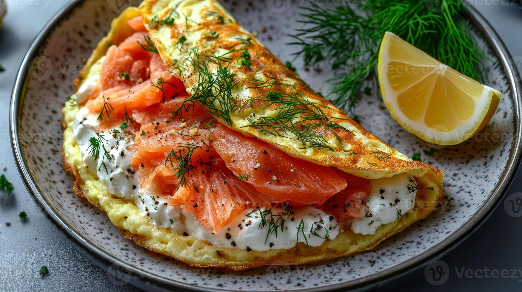 Omelette on a plate with salmon, cream cheese and dill photo