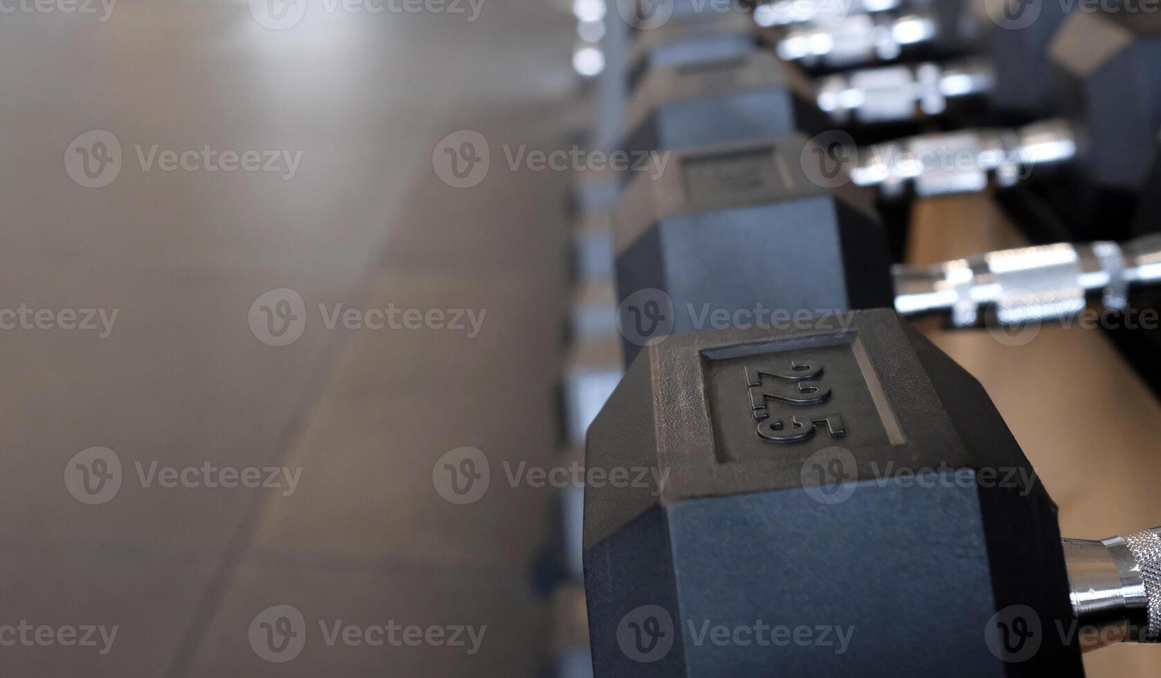 Selective focus on a row of weights in a gym photo