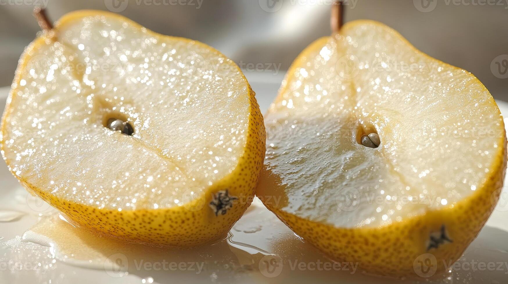 Close-up of a pear cut in half with black seeds photo