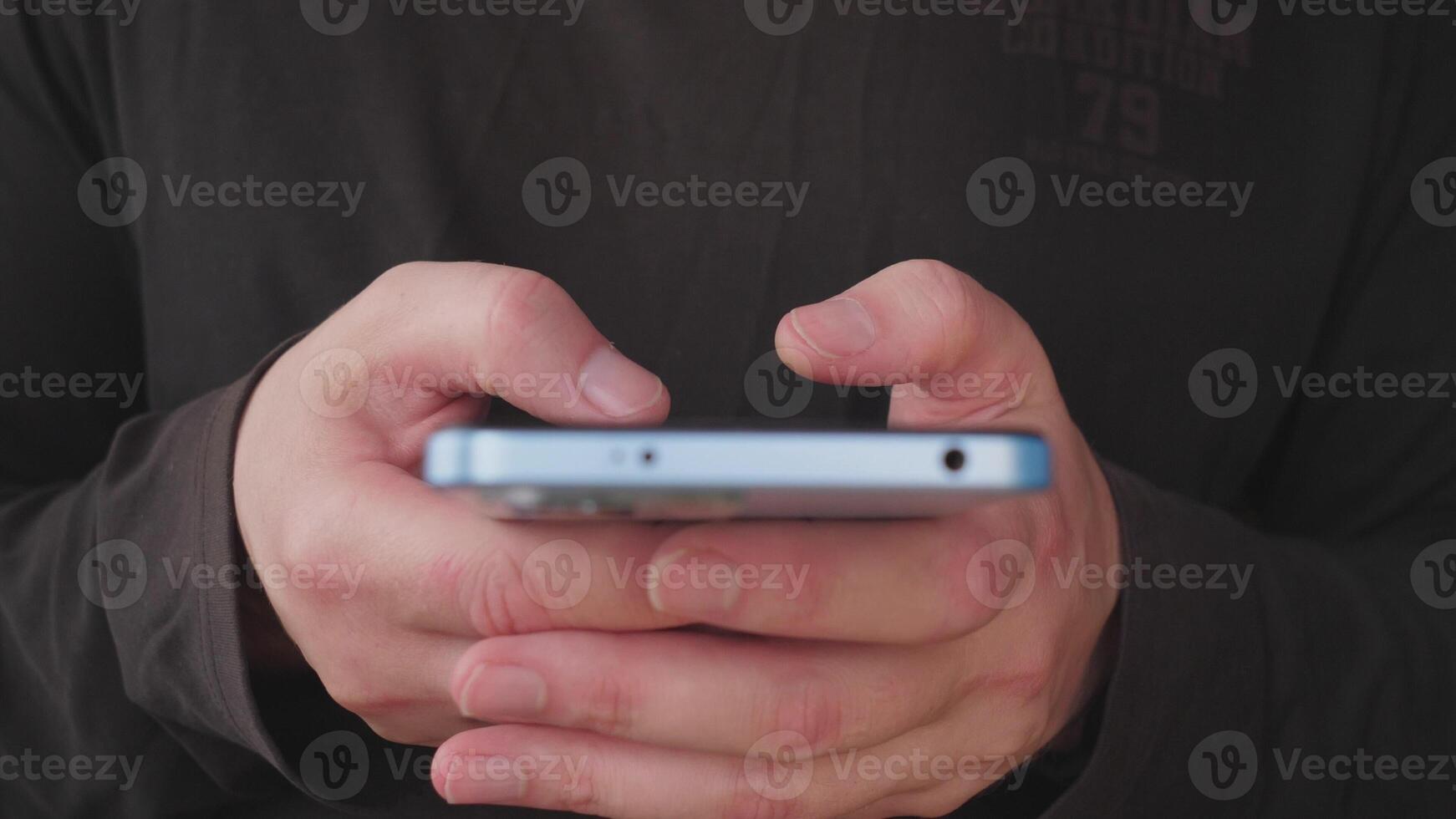 A closeup image of hands using a smartphone, showcasing modern communication and technology in daily life photo