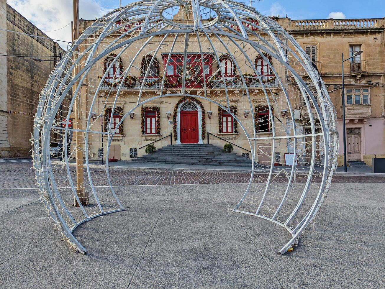 Paola, Malta,16.12.2024 - Christmas Light installation opposite Historic Maltese Building with Festive Holiday Decorations photo