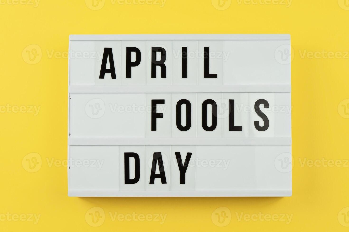 Lightbox Displaying April Fools Day Against Bright Yellow Background With Copy Space photo