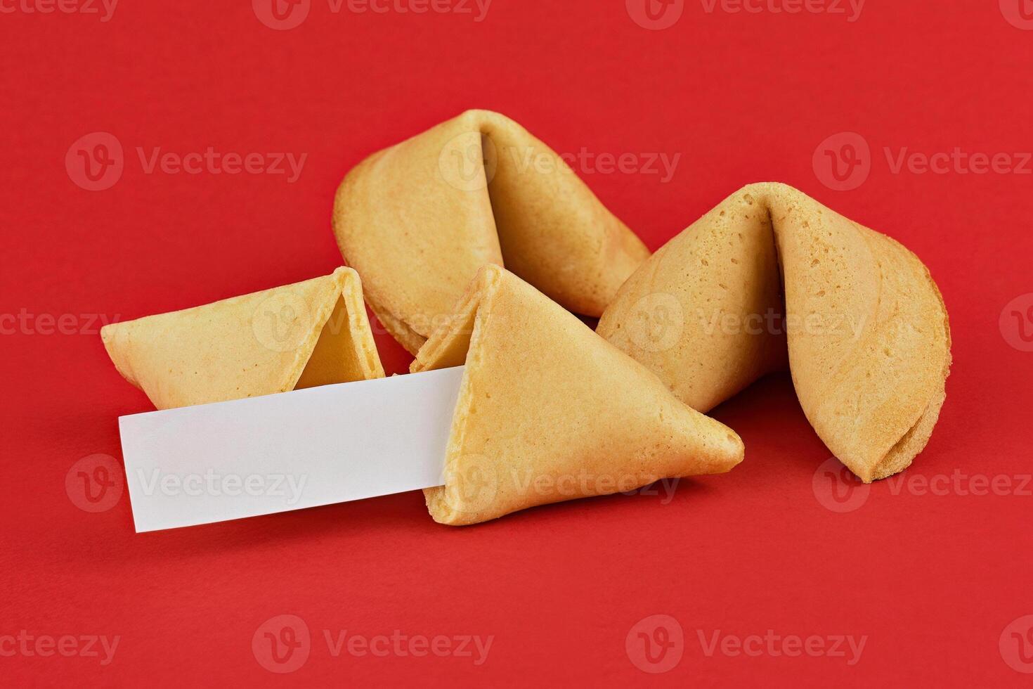 Fortune Cookies with Blank Fortune Slip on Vibrant Red Background with Copy Space photo