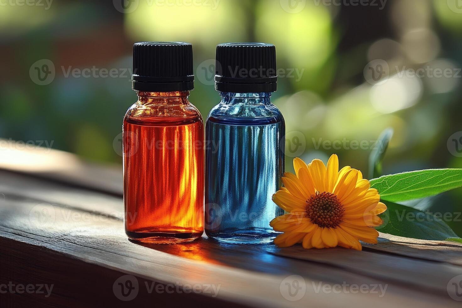Two Essential Oil Bottles on Wooden Surface with Yellow Flower and Leaf photo