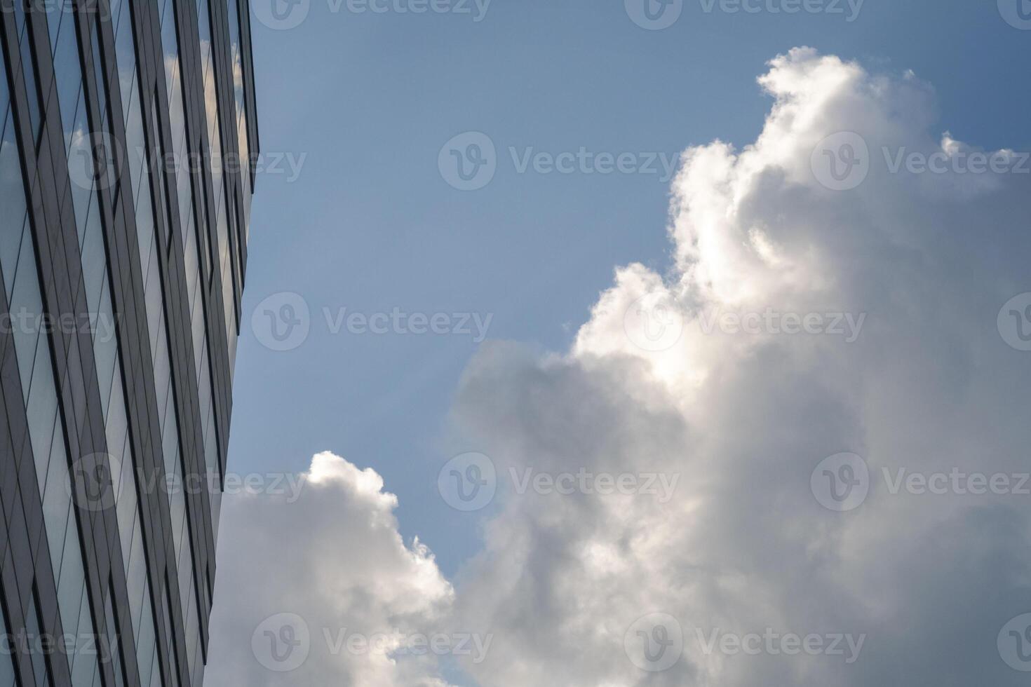 Clouds reflected on business building wall. Background image with copy space. photo