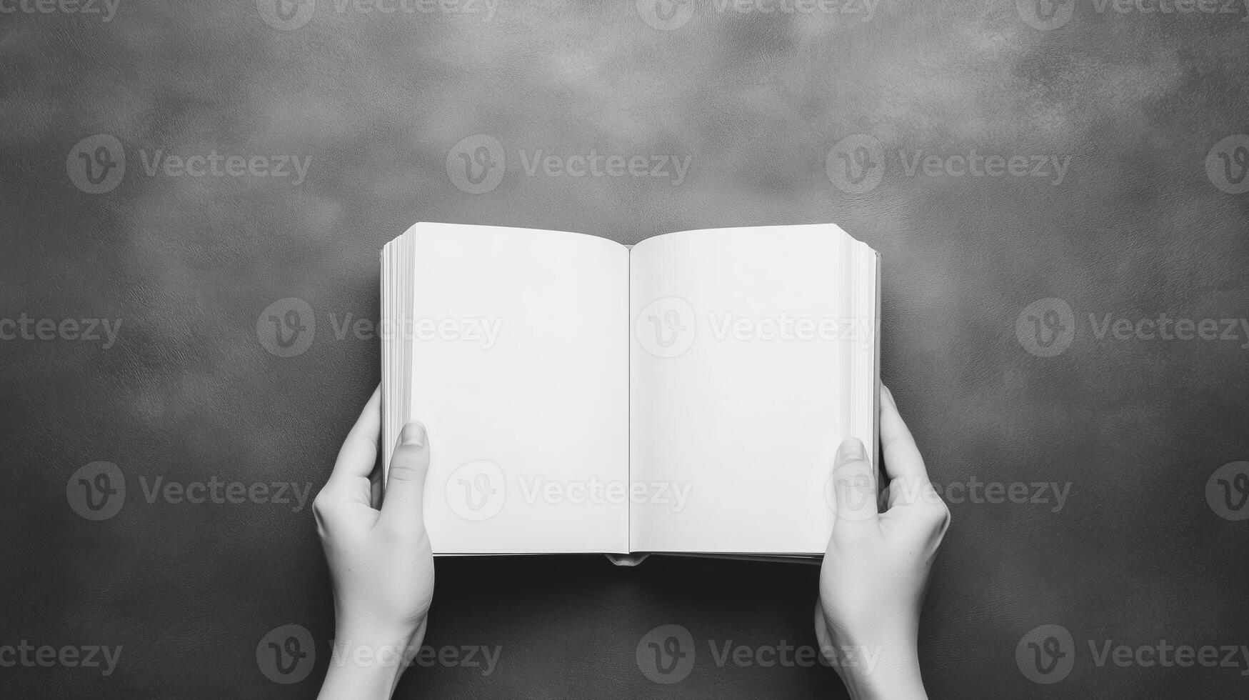 Hands Holding Open Book for Learning and Knowledge Concepts in Black and White Minimalist Design photo